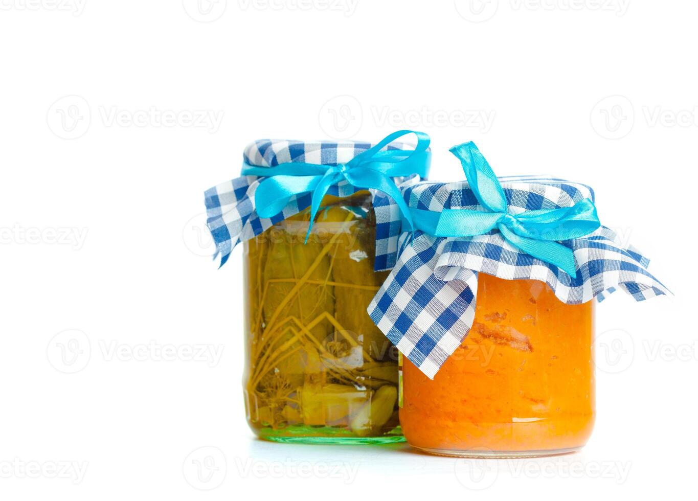 Canned vegetables in glass jars isolated on white background photo