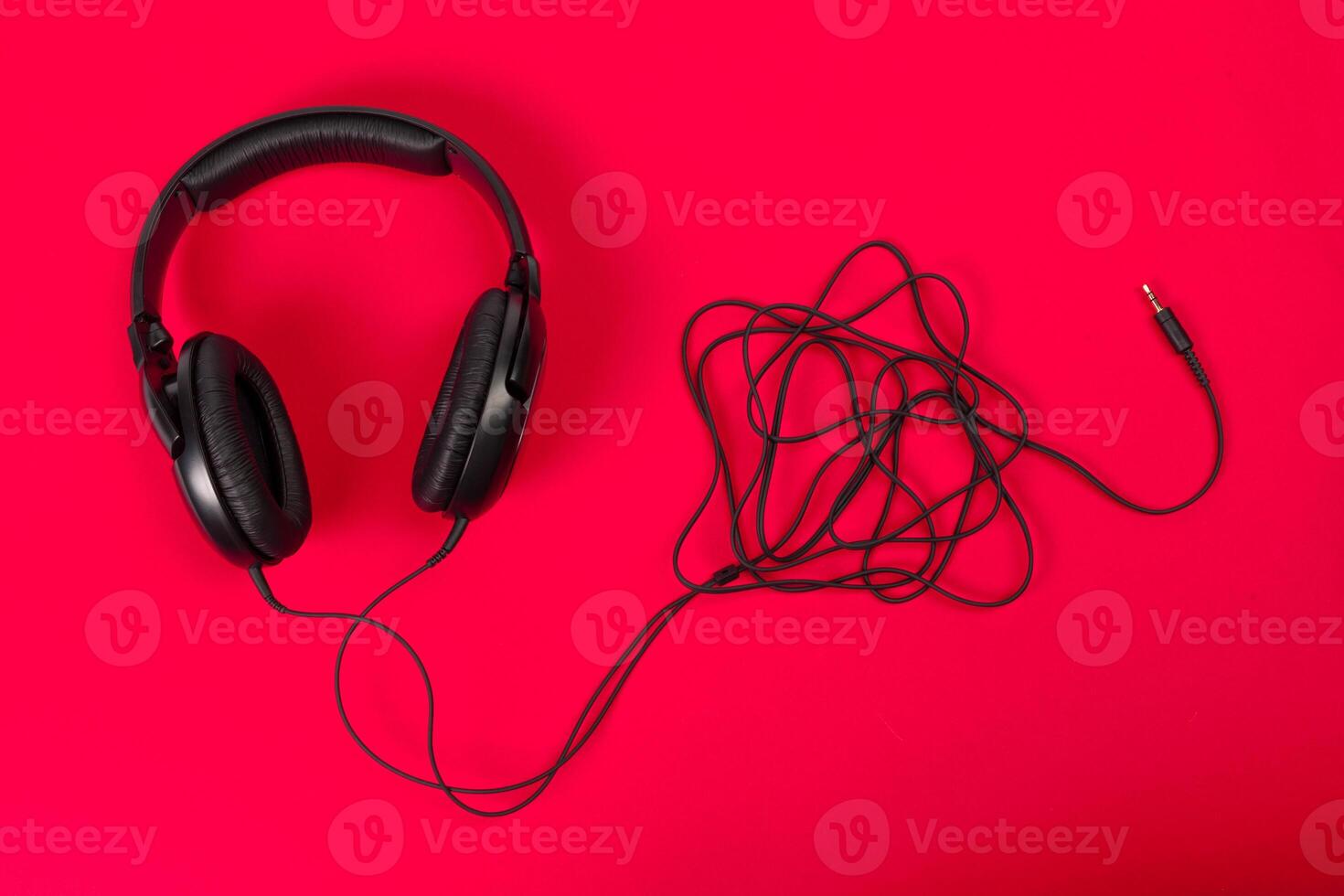 headphones on red surface photo