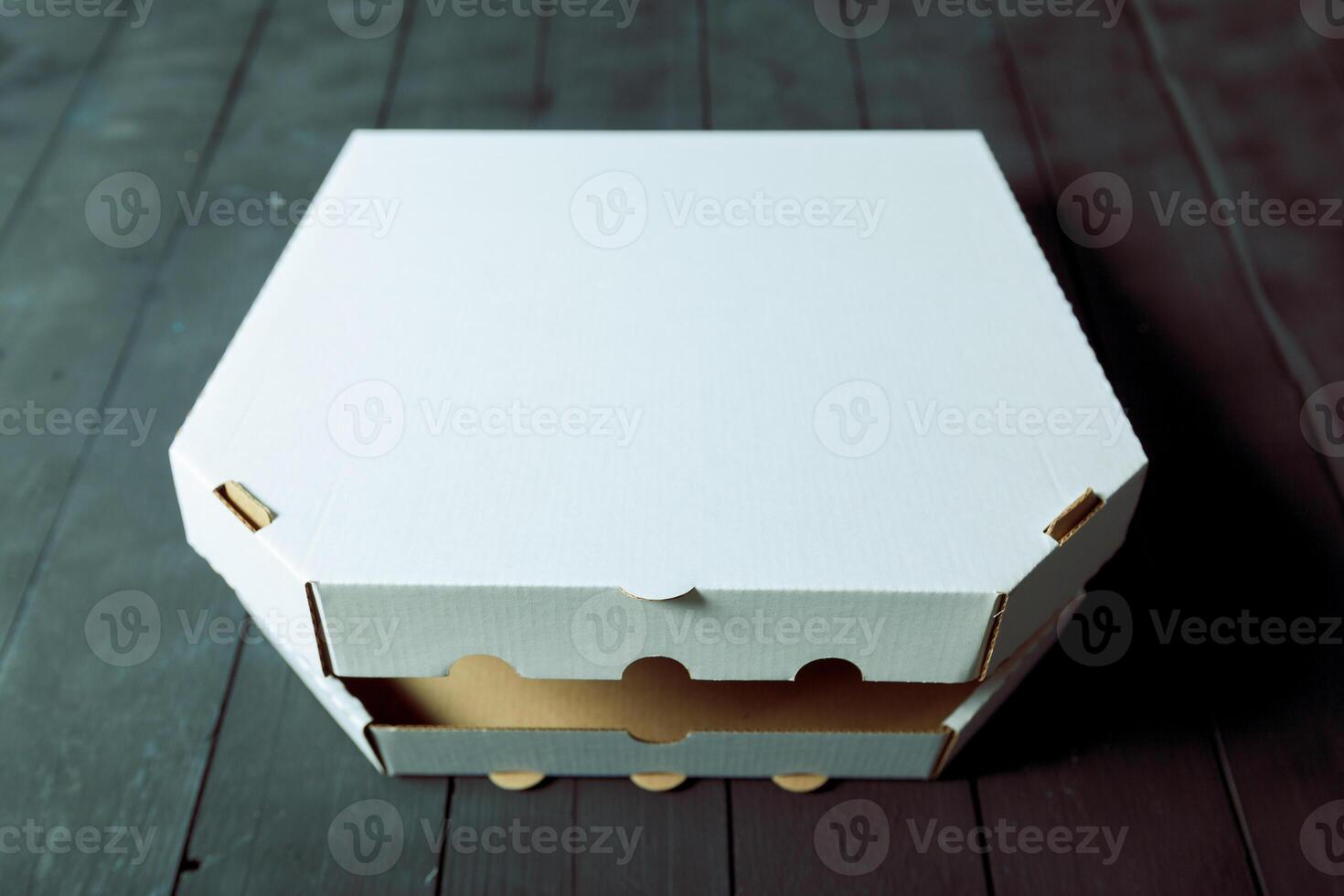 Empty cardboard pizza box on wooden table photo