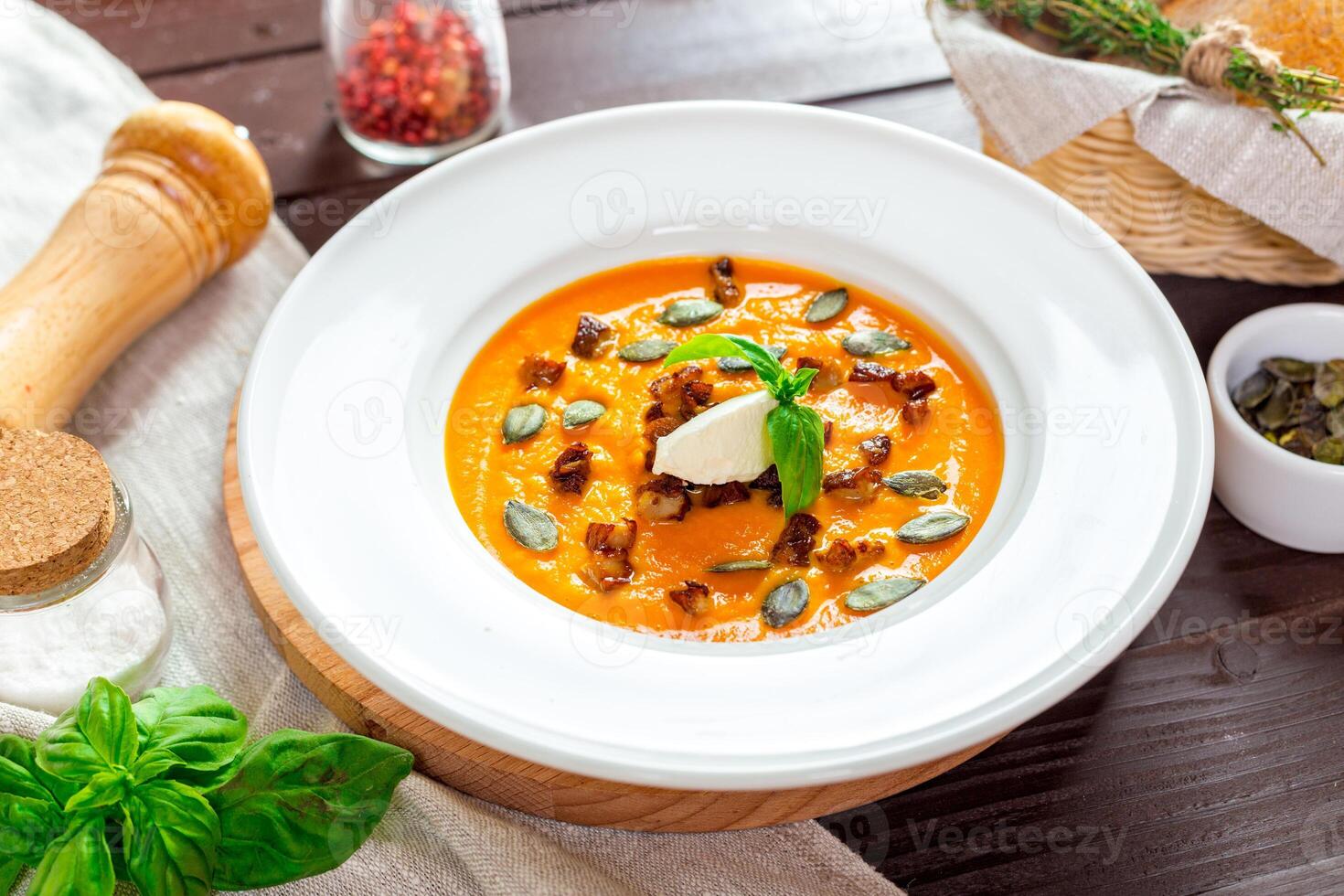 Pumpkin soup in white plate photo