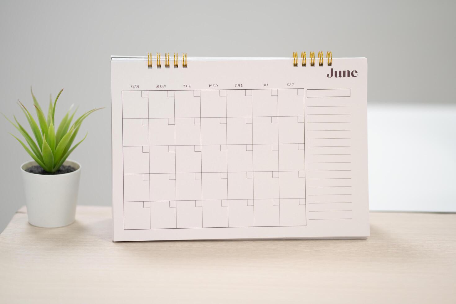 Desk calendar for June on the table with copy space in work space concept. photo