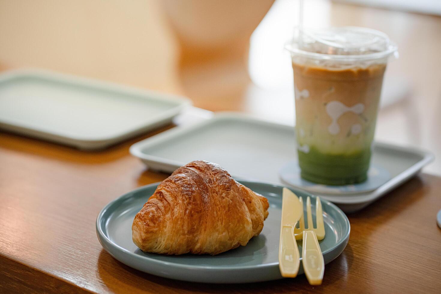 croissant in plate on the wooden table at coffee shop.flat lay food concept. photo
