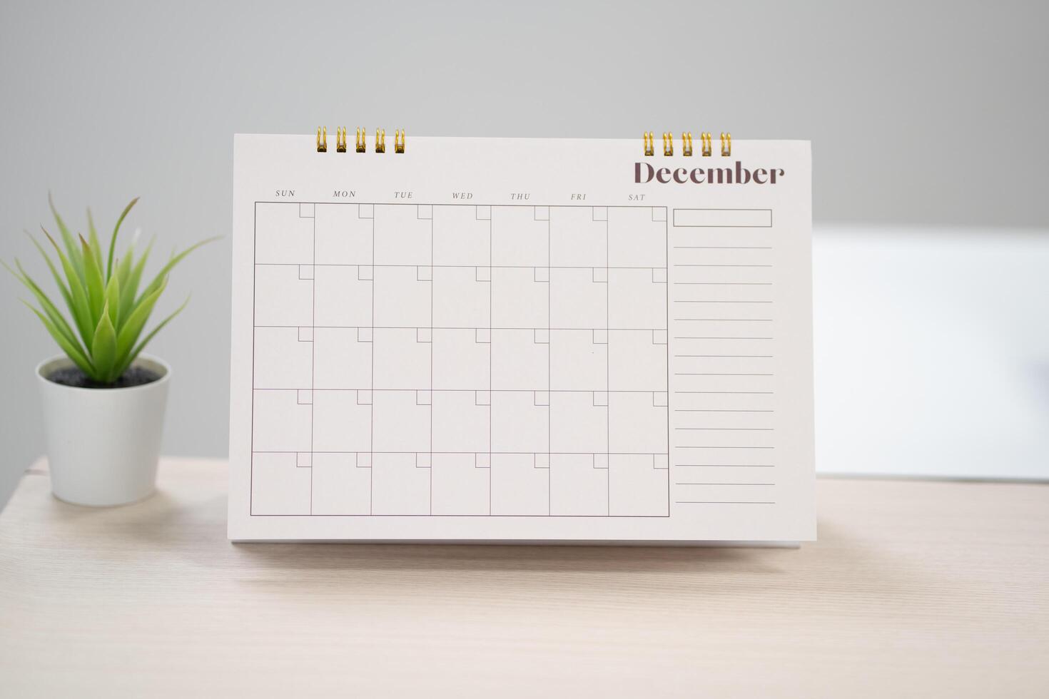 Desk calendar for December on the table with copy space in work space concept. photo
