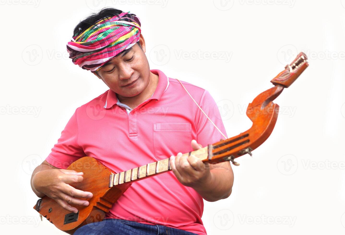 Asian man is playing Thai traditional lute, folk guitar. Musical instrument. Concept, love music, hobby, recreation activity. Relax time. Lifestyle. Music can develop mental health. photo