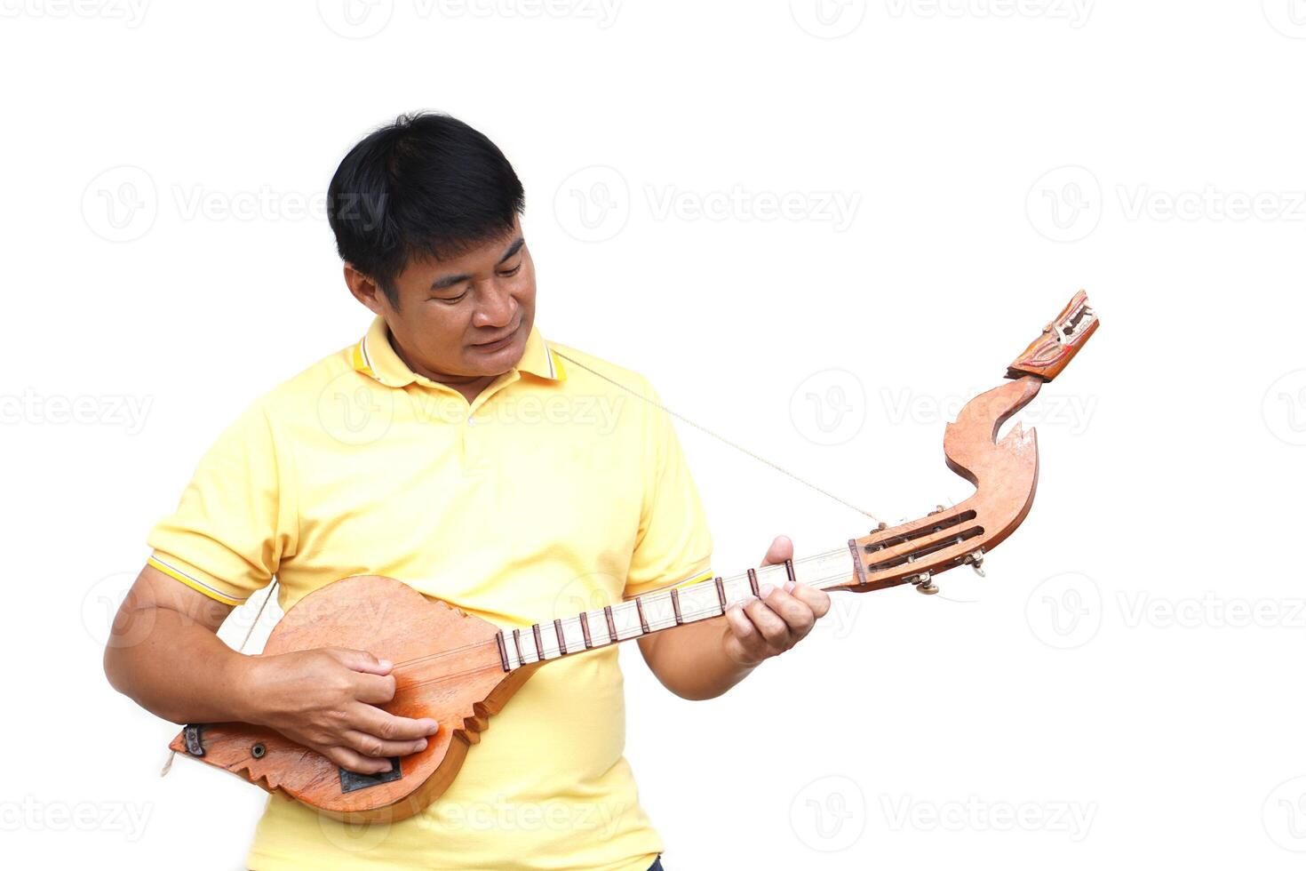 Asian man is playing Thai traditional lute, folk guitar. Musical instrument. Concept, love music, hobby, recreation activity. Relax time. Lifestyle. Music can develop mental health. photo