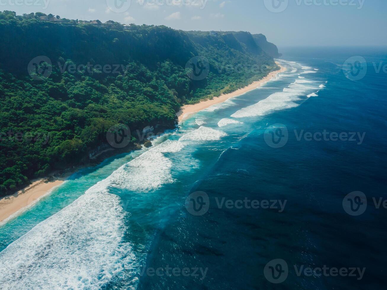 Drone view of coastline with ocean waves and tropical wild beach in Bali. photo