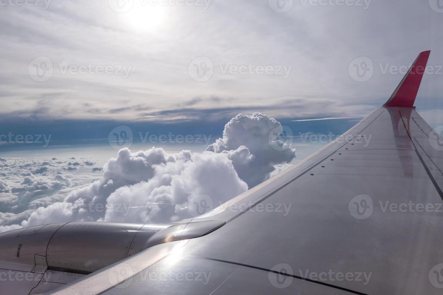 Airplane wing flying on clouds in sky photo