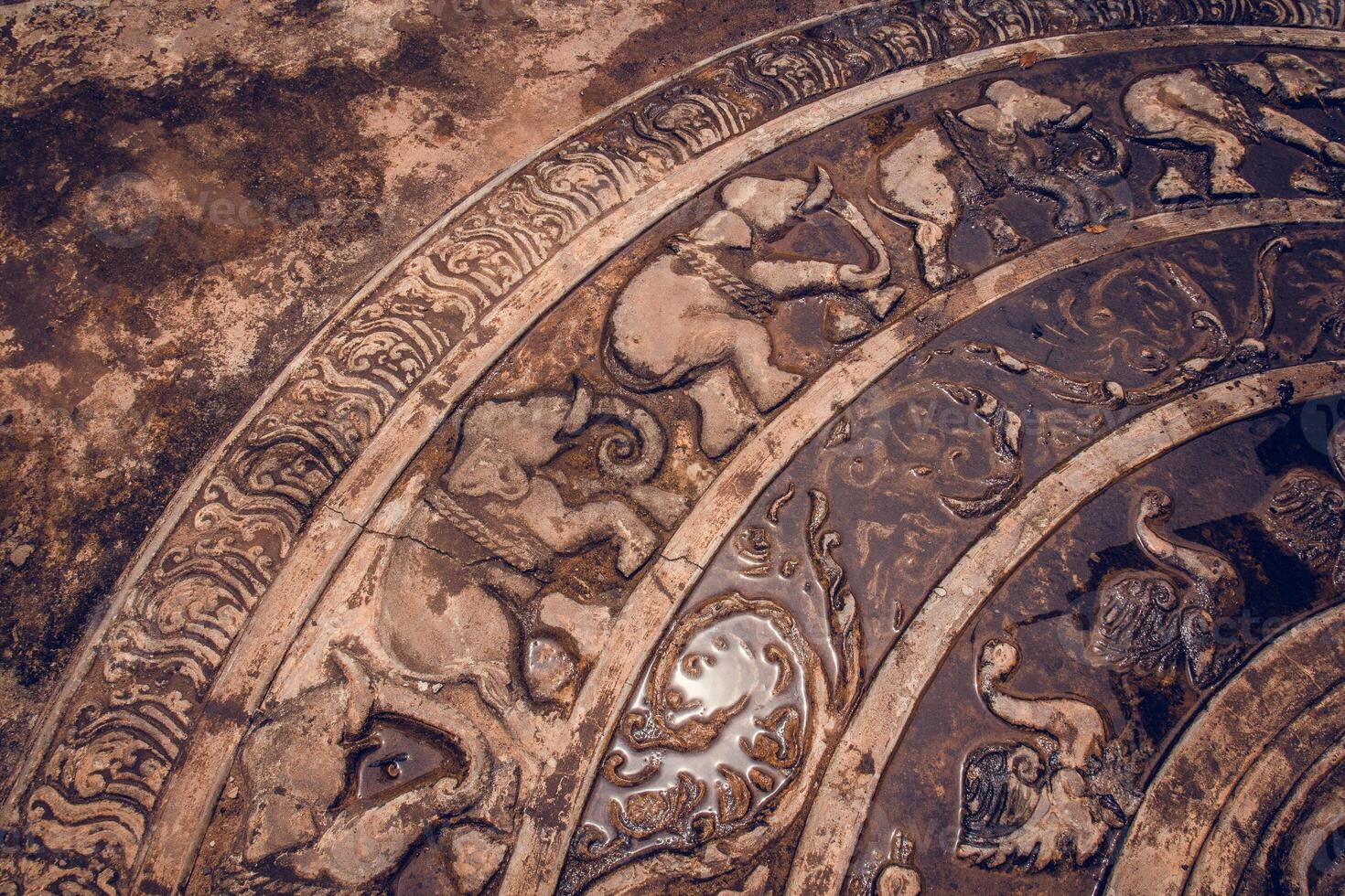 An ancient stone carving with intricate animal designs and patterns photo