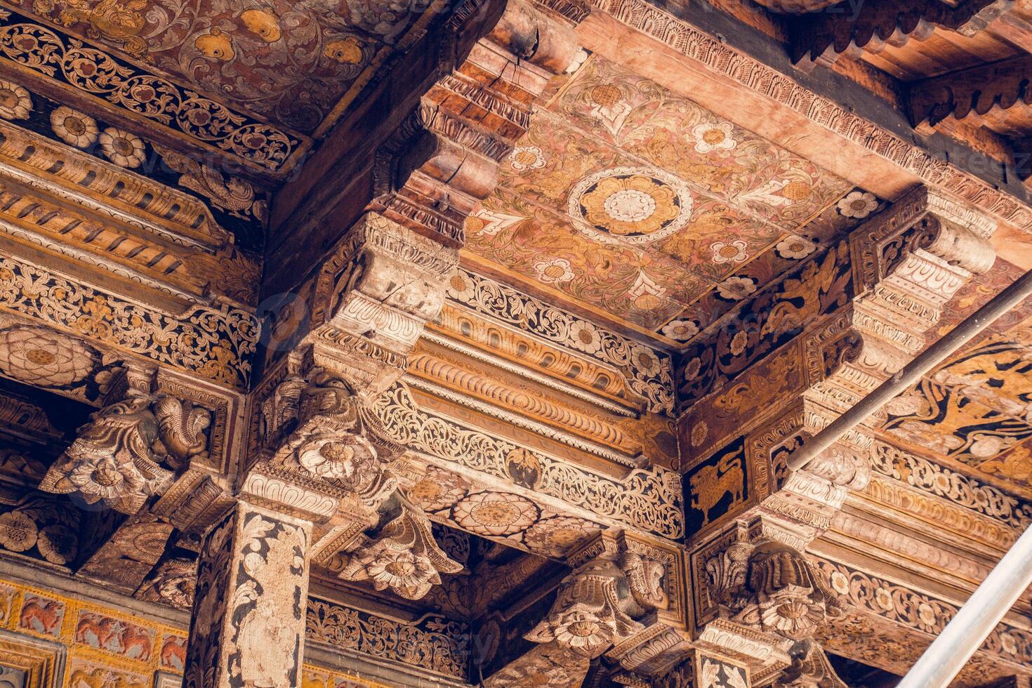Wooden ceiling with intricate patterns and embossed ornament photo
