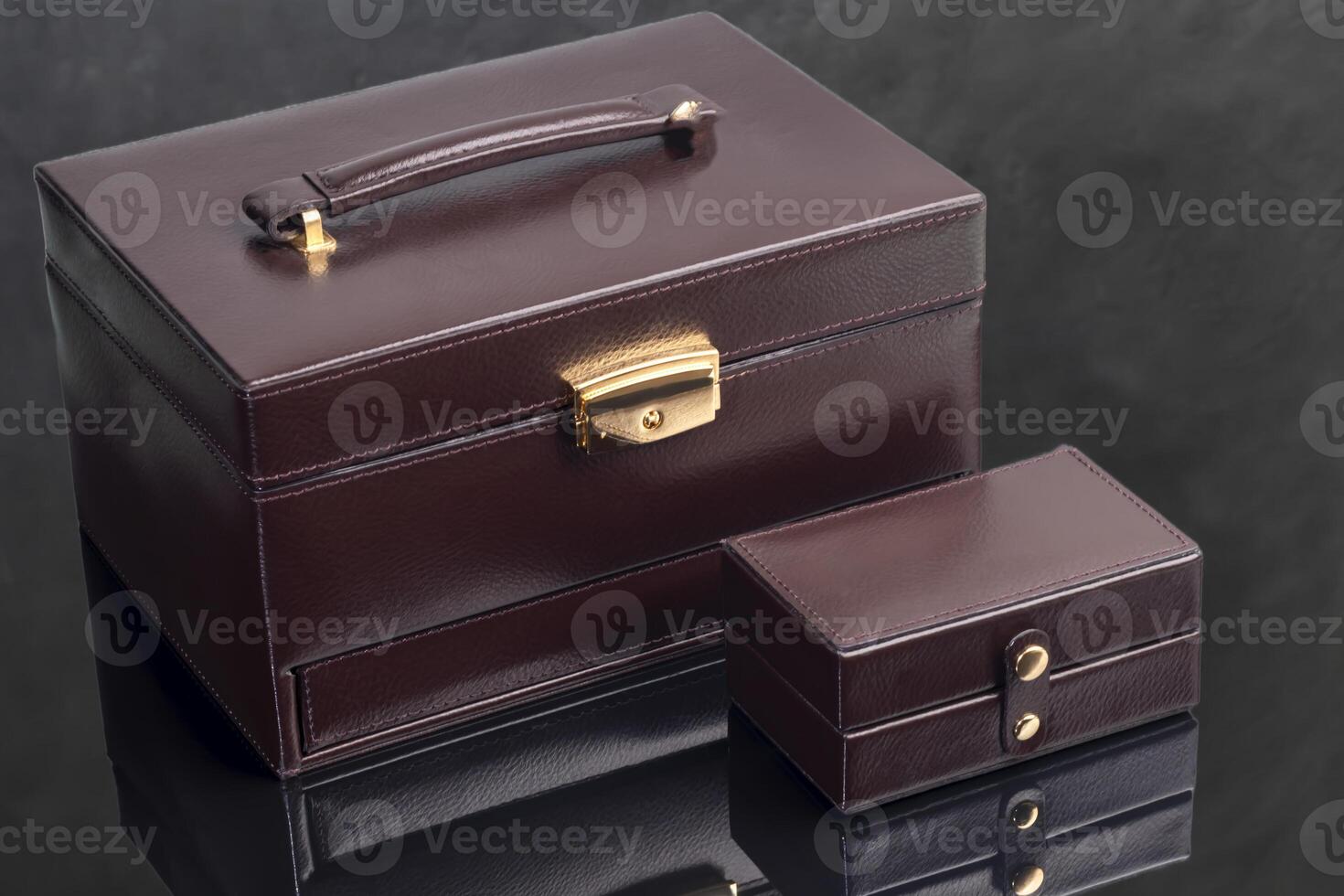 Brown leather case for storing various jewelry with a small box for a ring. photo