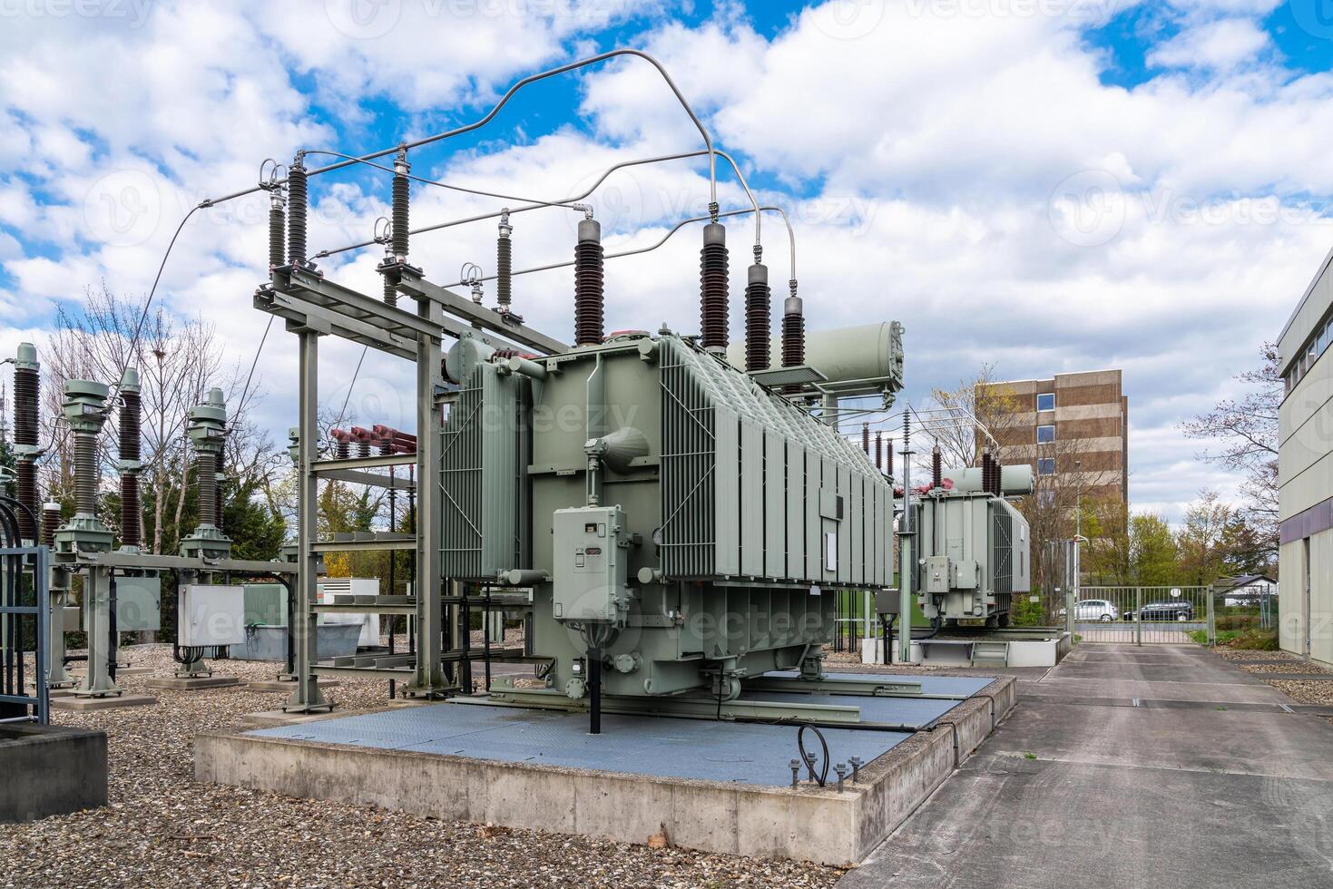 A large stationary electrical transformer against a cloudy sky. photo