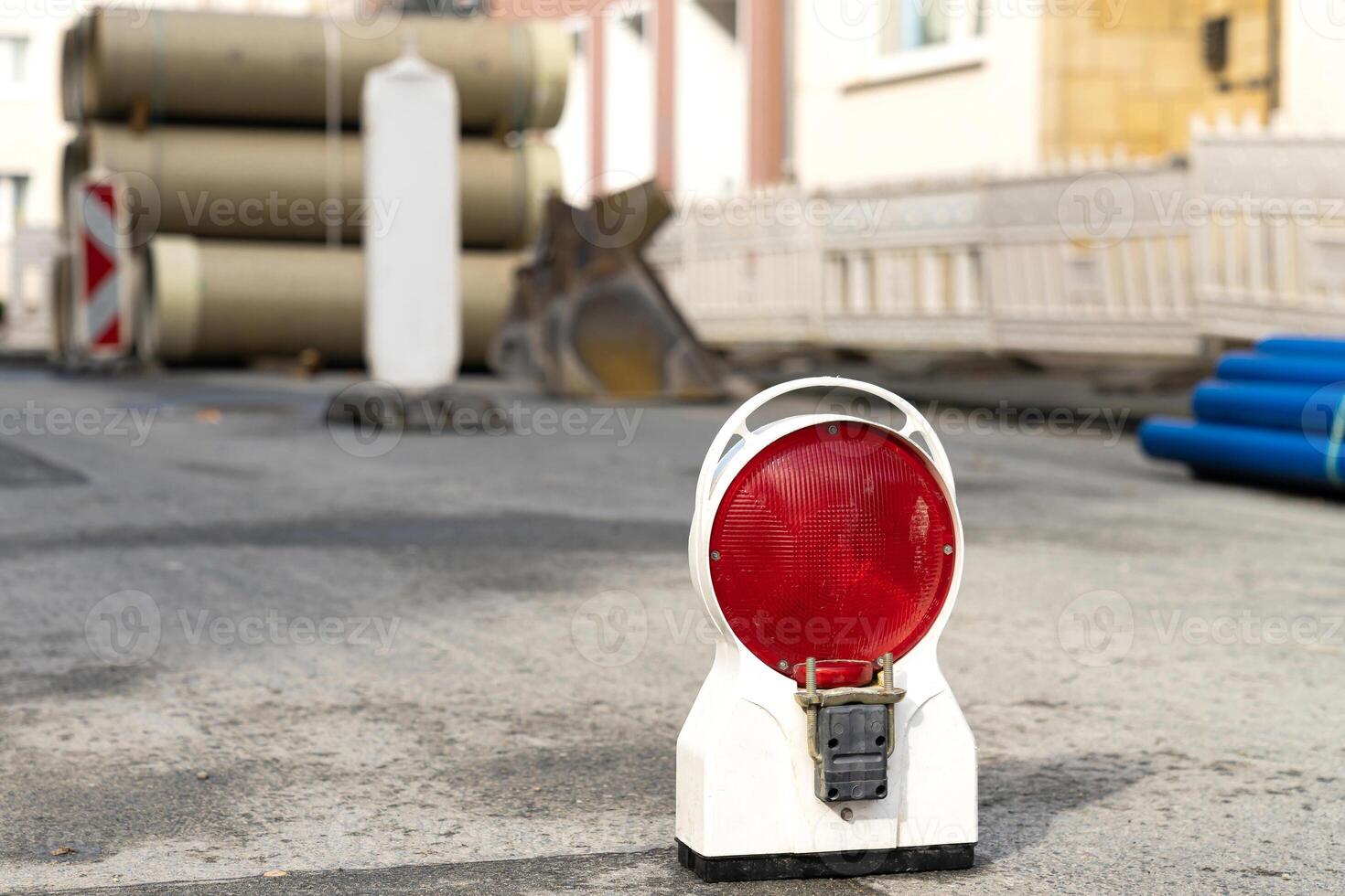 Portable red signal light warns of danger at a construction site. photo