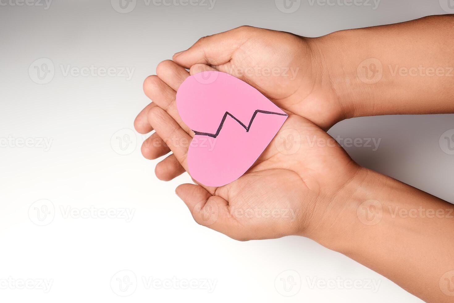 the hand holds a broken heart photo