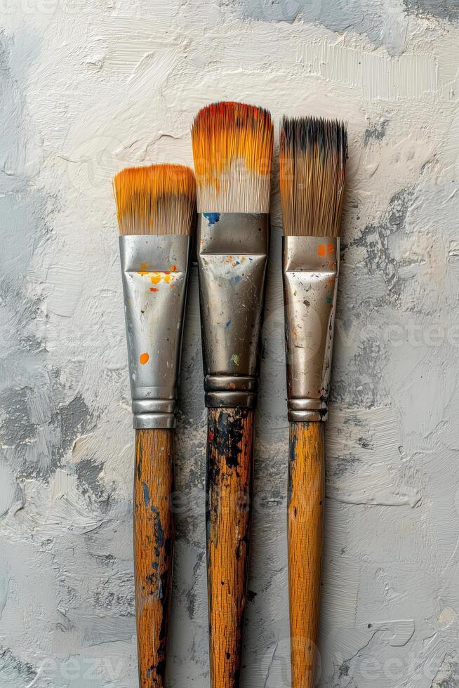 Creative flat lay composition with paint brushes on light grey background photo