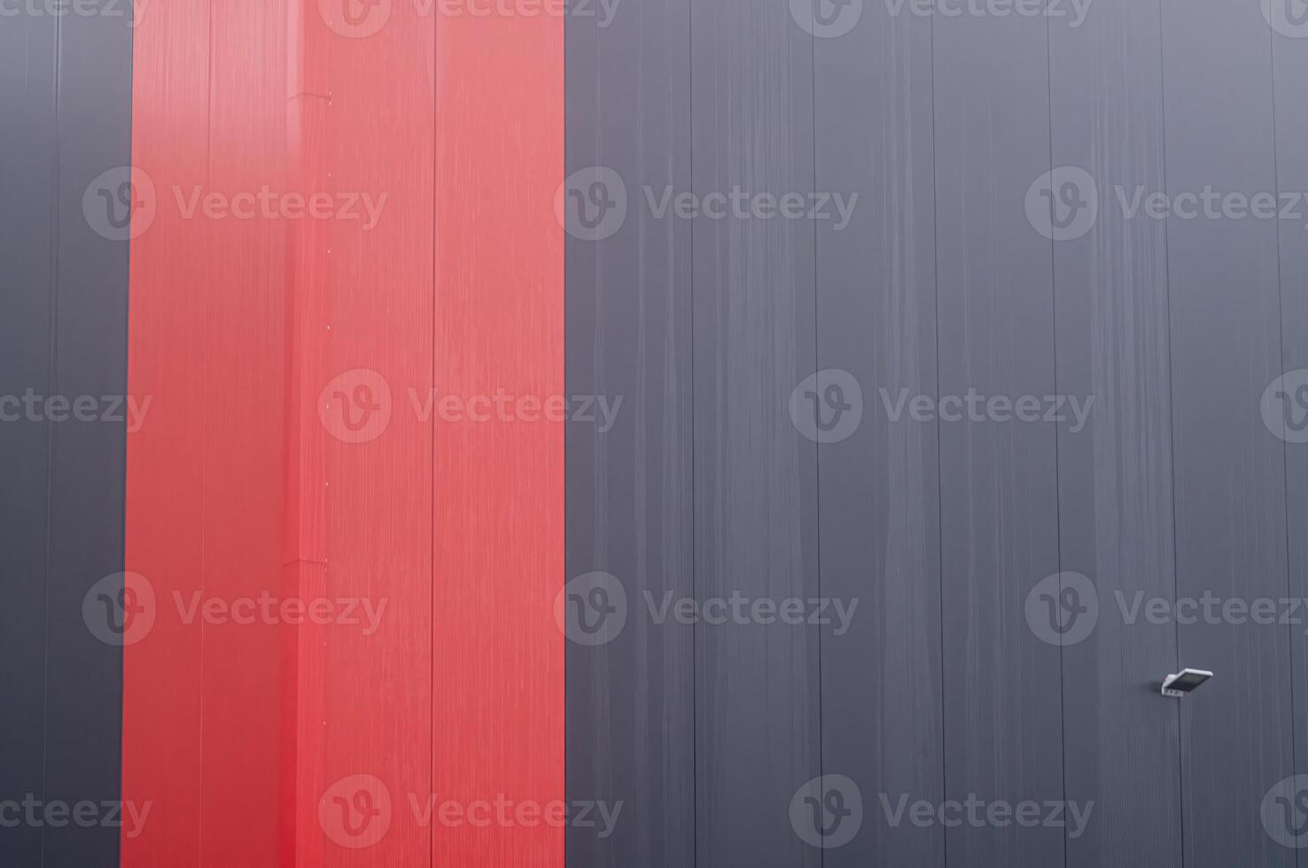 Red and gray corrugated metal wall creating modern abstract design photo
