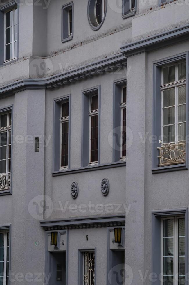 Elegant grey facade with decorative elements and windows photo