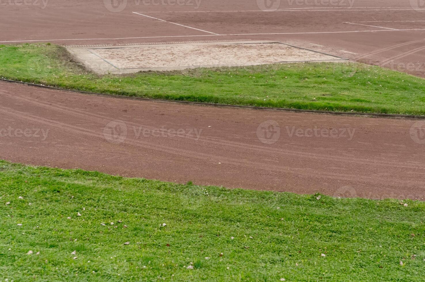 Long jump sand pit and running track on a cloudy day photo