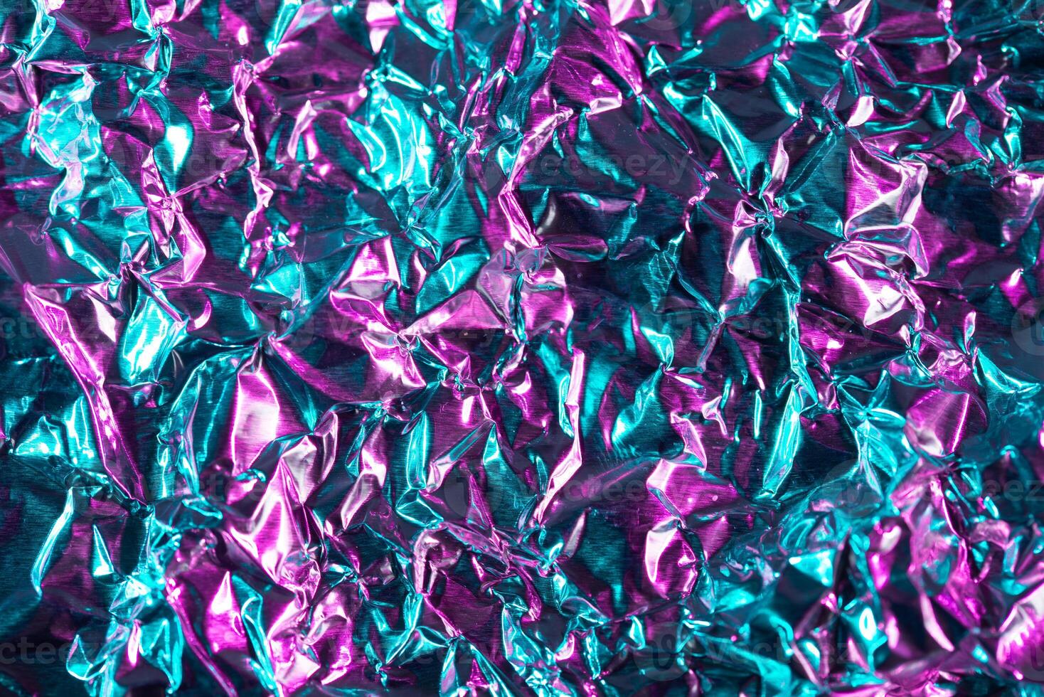 Crumpled iridescent metallic texture background photo