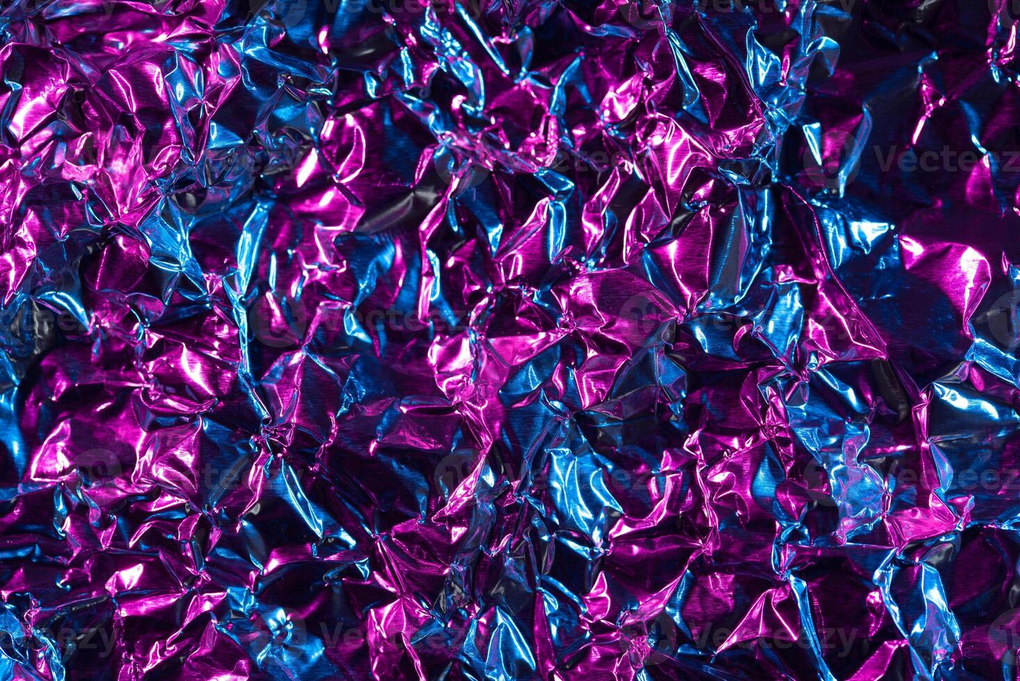 Vibrant metallic crumpled foil texture photo