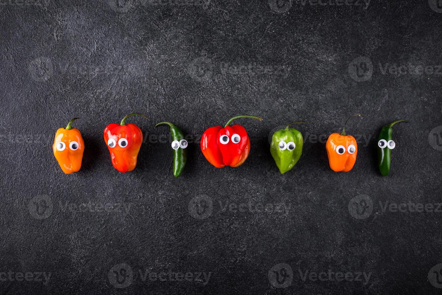 Cute color bell pepper with eyes. photo
