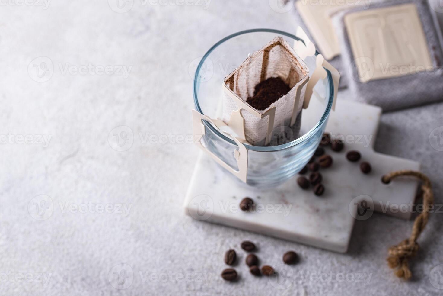 Freshly brewed drip coffee in glass cup photo