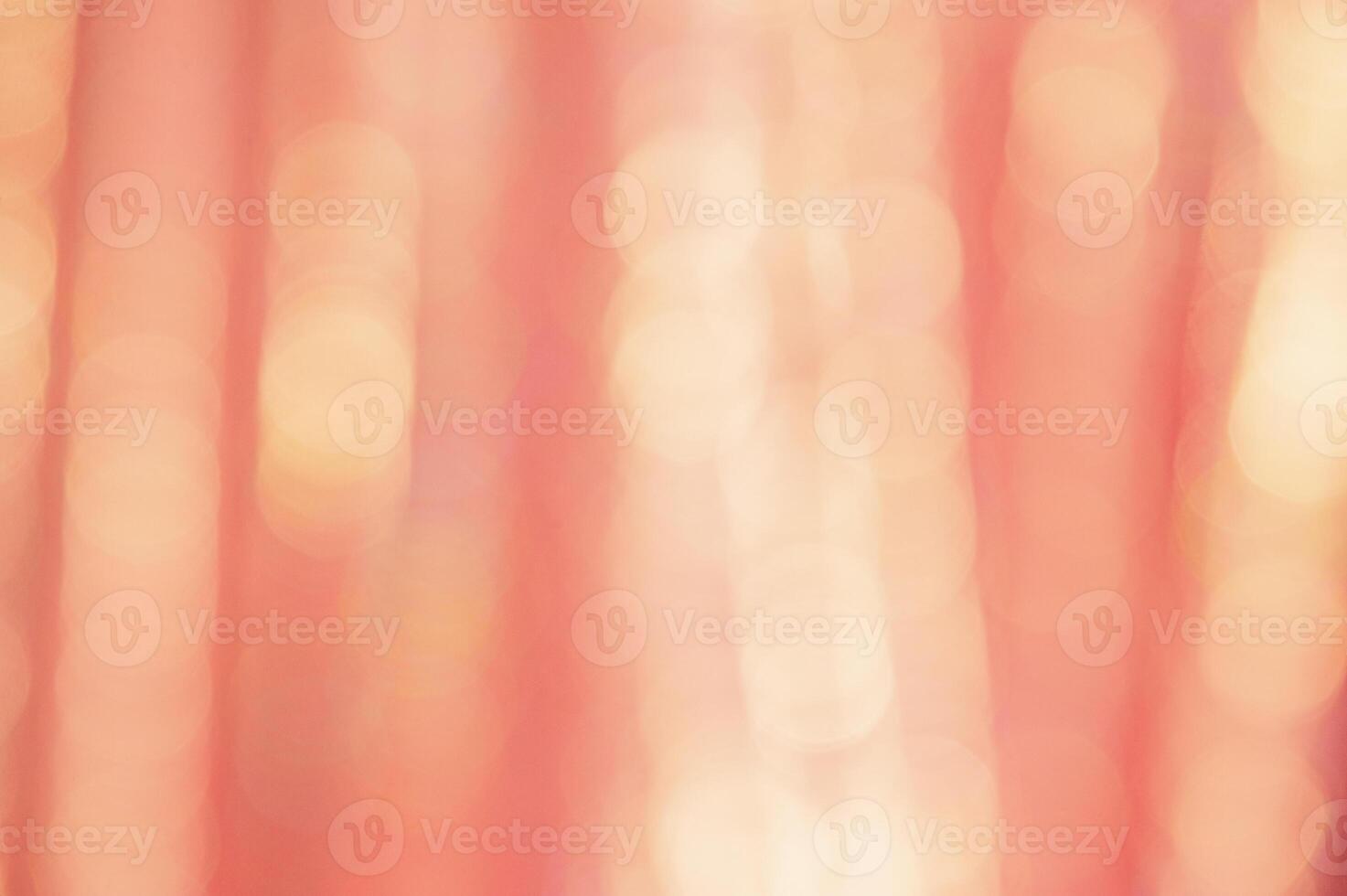 Defocused peach glitter background with sparkles. Defocus light is yellow and orange. photo