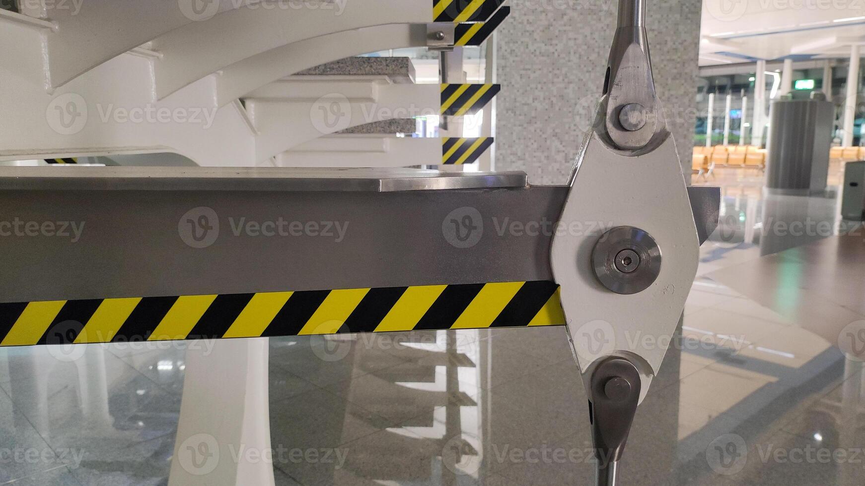 Close-up of metal support structure with caution stripes in modern interior photo