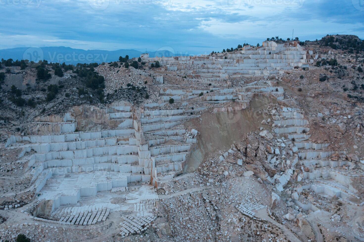Open-air mining activity in a white marble mine. photo