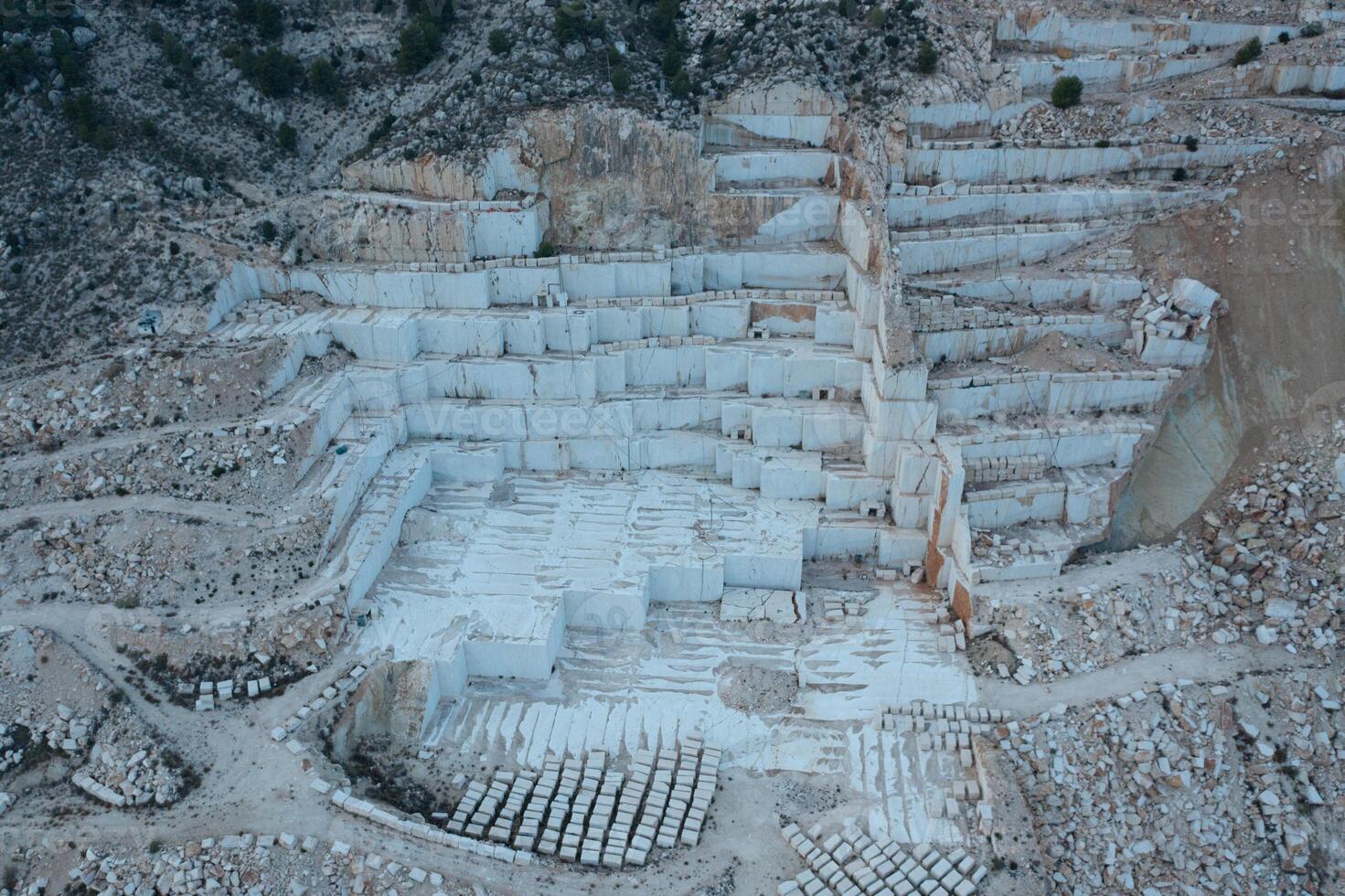 Aerial view of Open-air mining activity in a white marble mine. photo