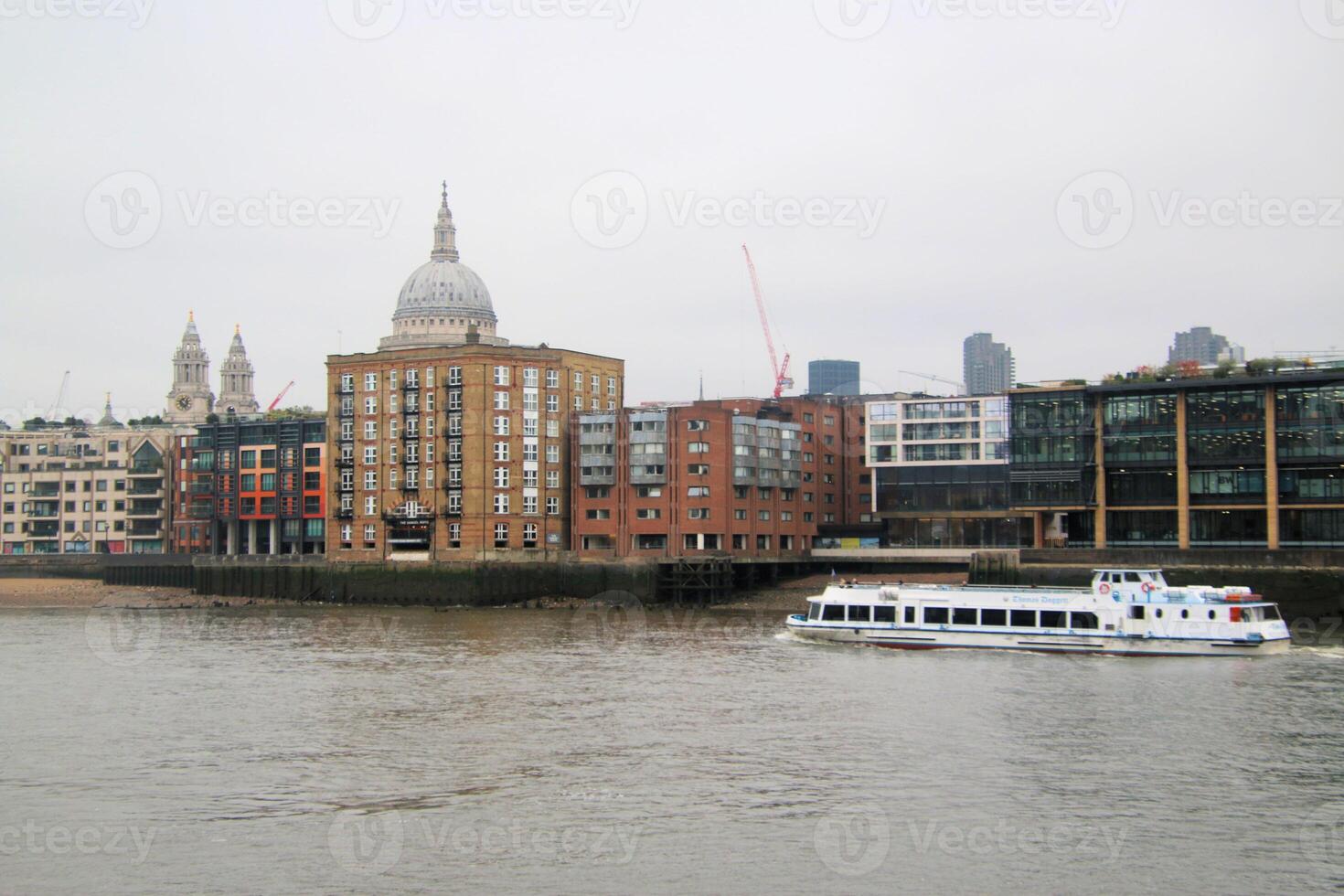 A boat is traveling down a river in front of a building photo