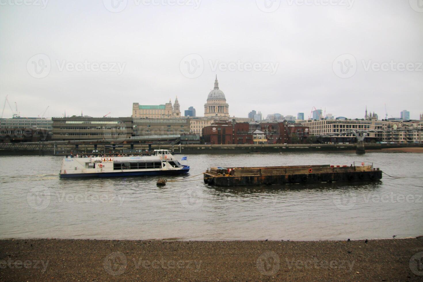 A boat is floating in the water next to a building photo