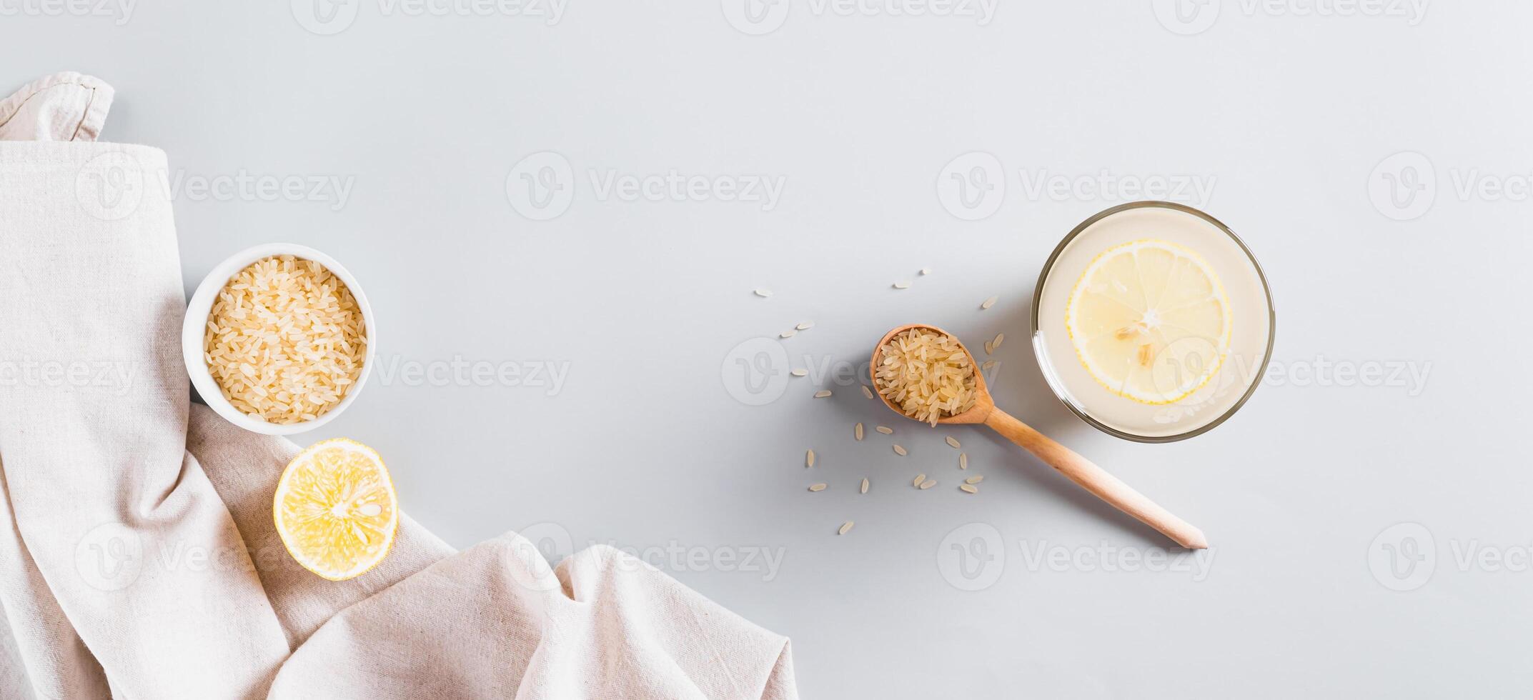 Trendy rice and lemon drink to reduce appetite in a glass on the table top view web banner photo