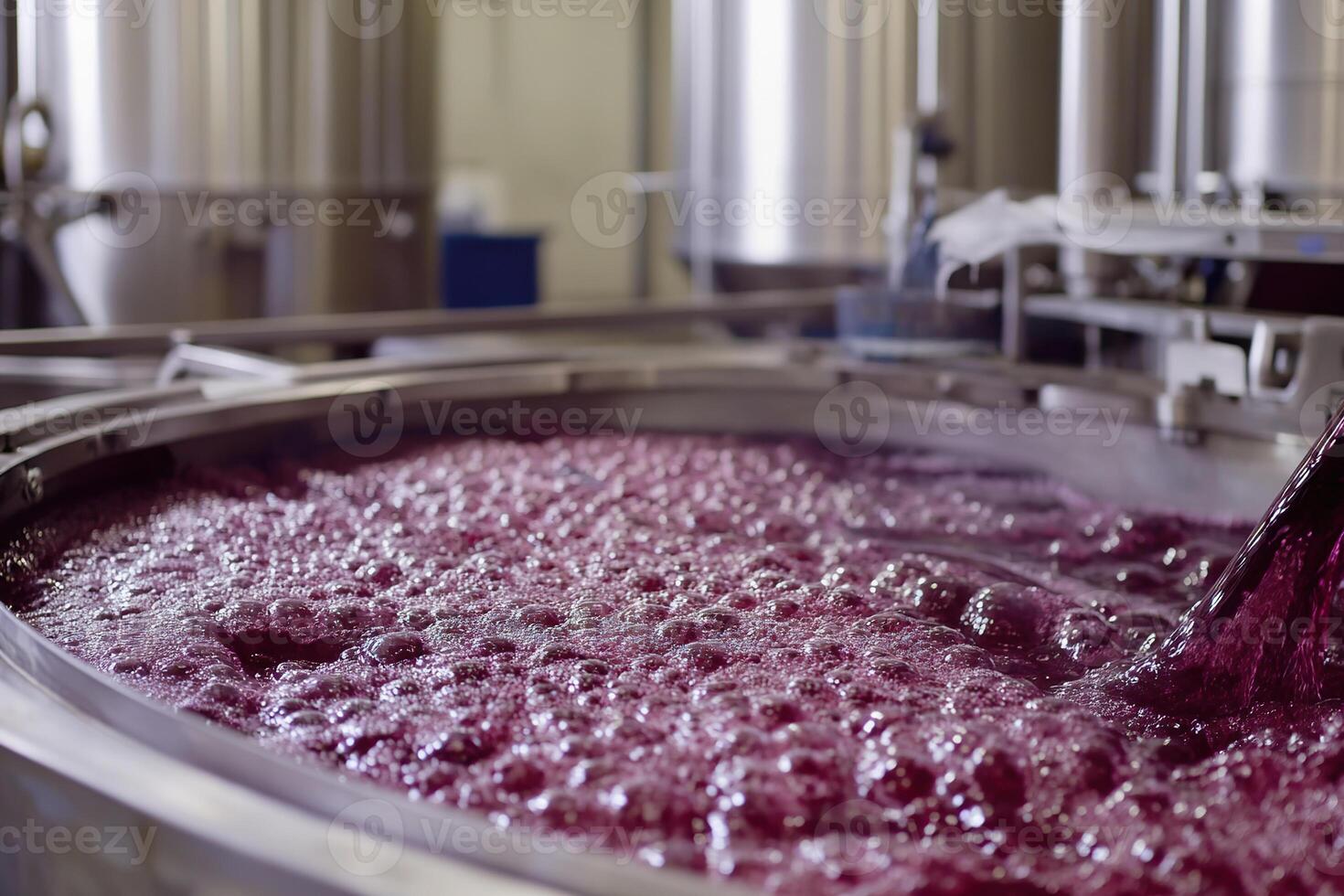 Bubbling fermentation process in a winery with stainless steel vats and flowing red wine photo