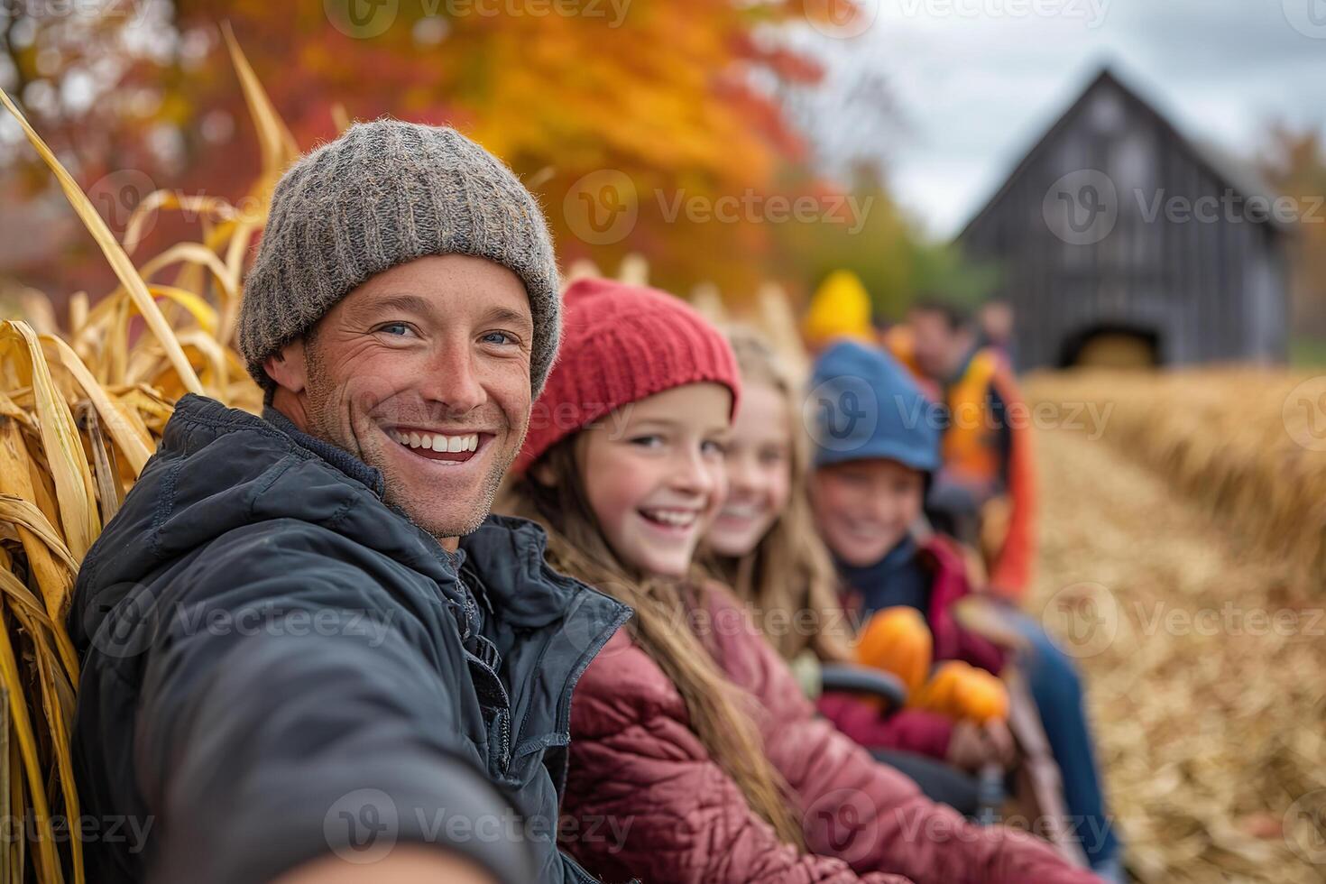 Family enjoying a hayride amidst vibrant autumn foliage in a rural setting. photo
