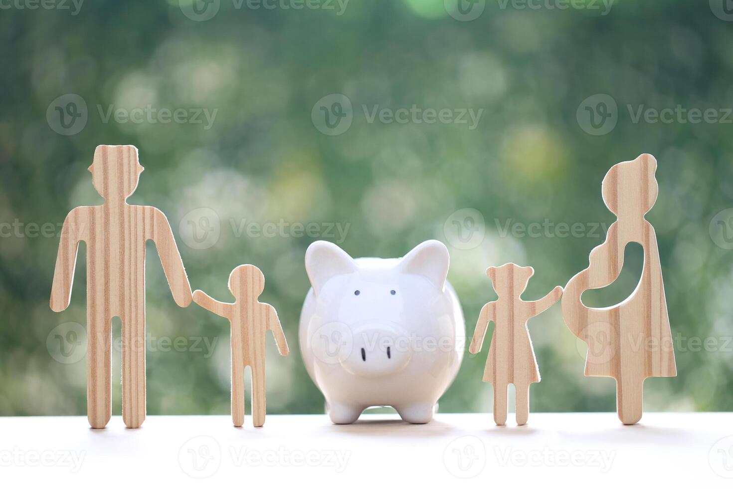 Model family with piggy bank and stack of coins money on natural green background,Save money for prepare in future and family finance concept photo