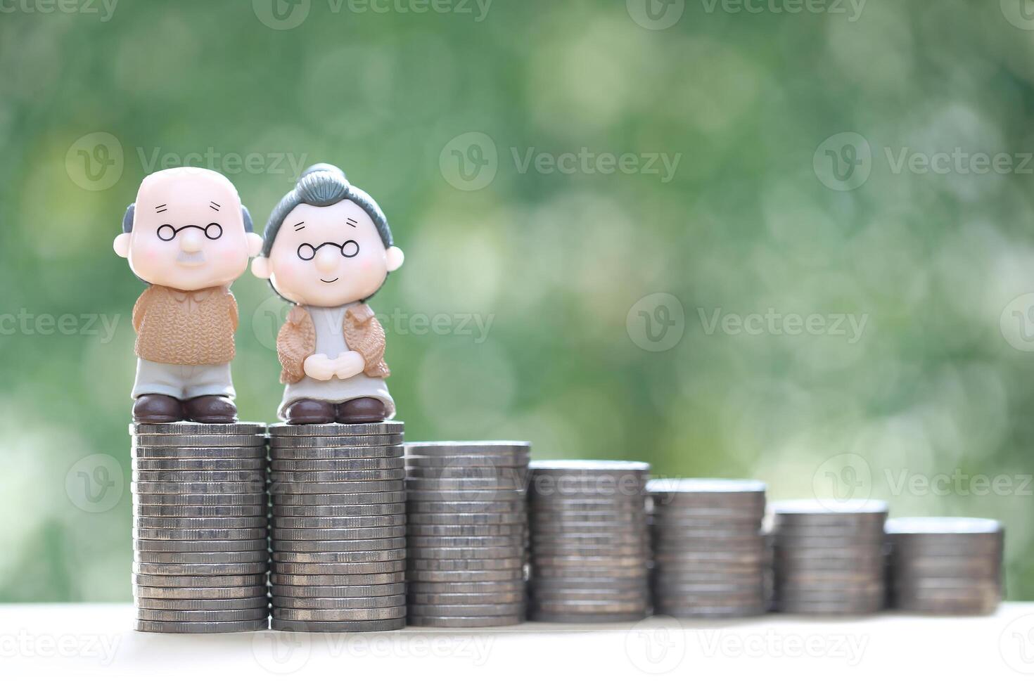 Mutual fund,Love couple senior and stack of coins money on natural green background, Save money for prepare in future and pension retirement concept photo