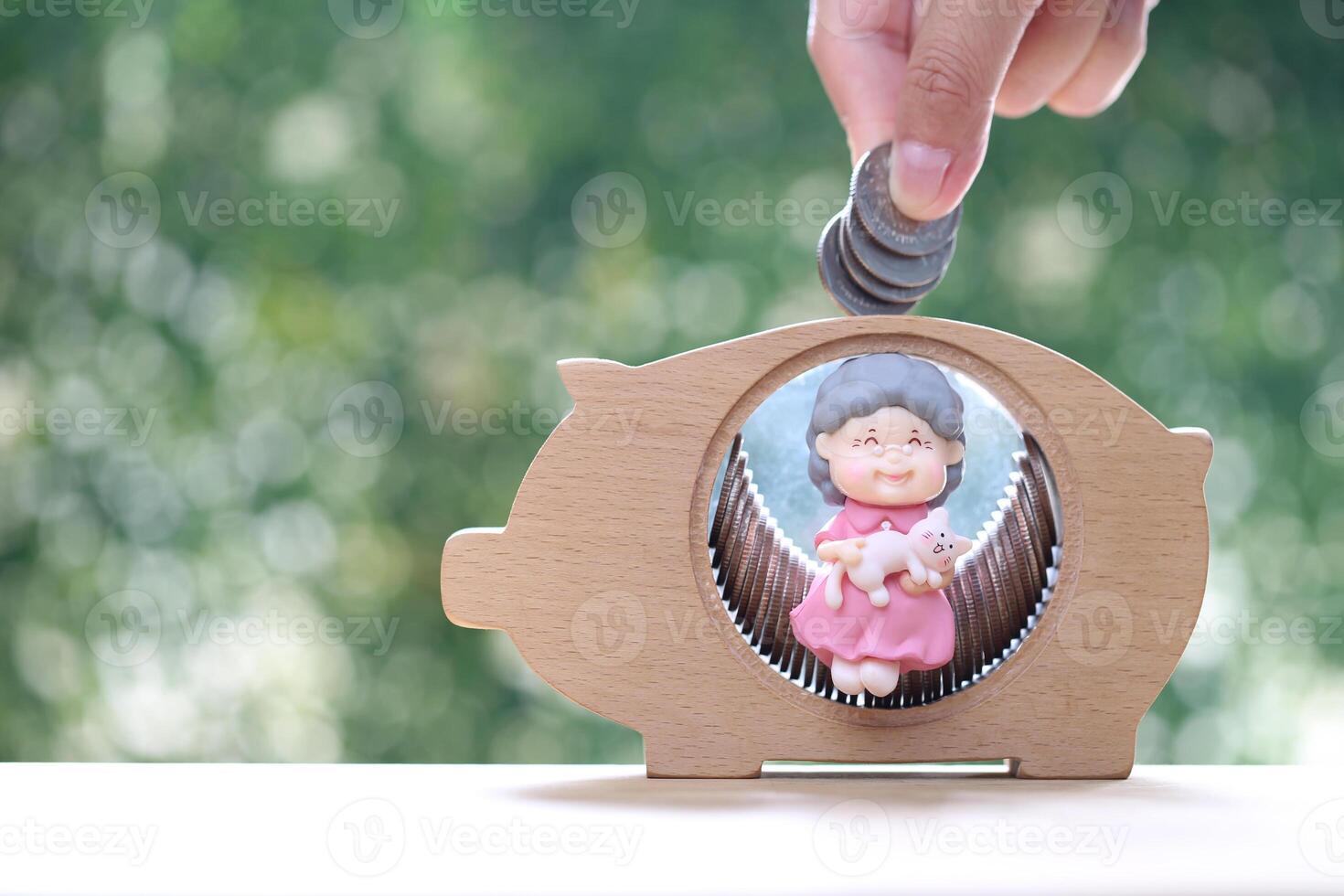 Mutual fund,Senior and piggy bank on natural green background, Save money for prepare in future and pension retirement concept photo