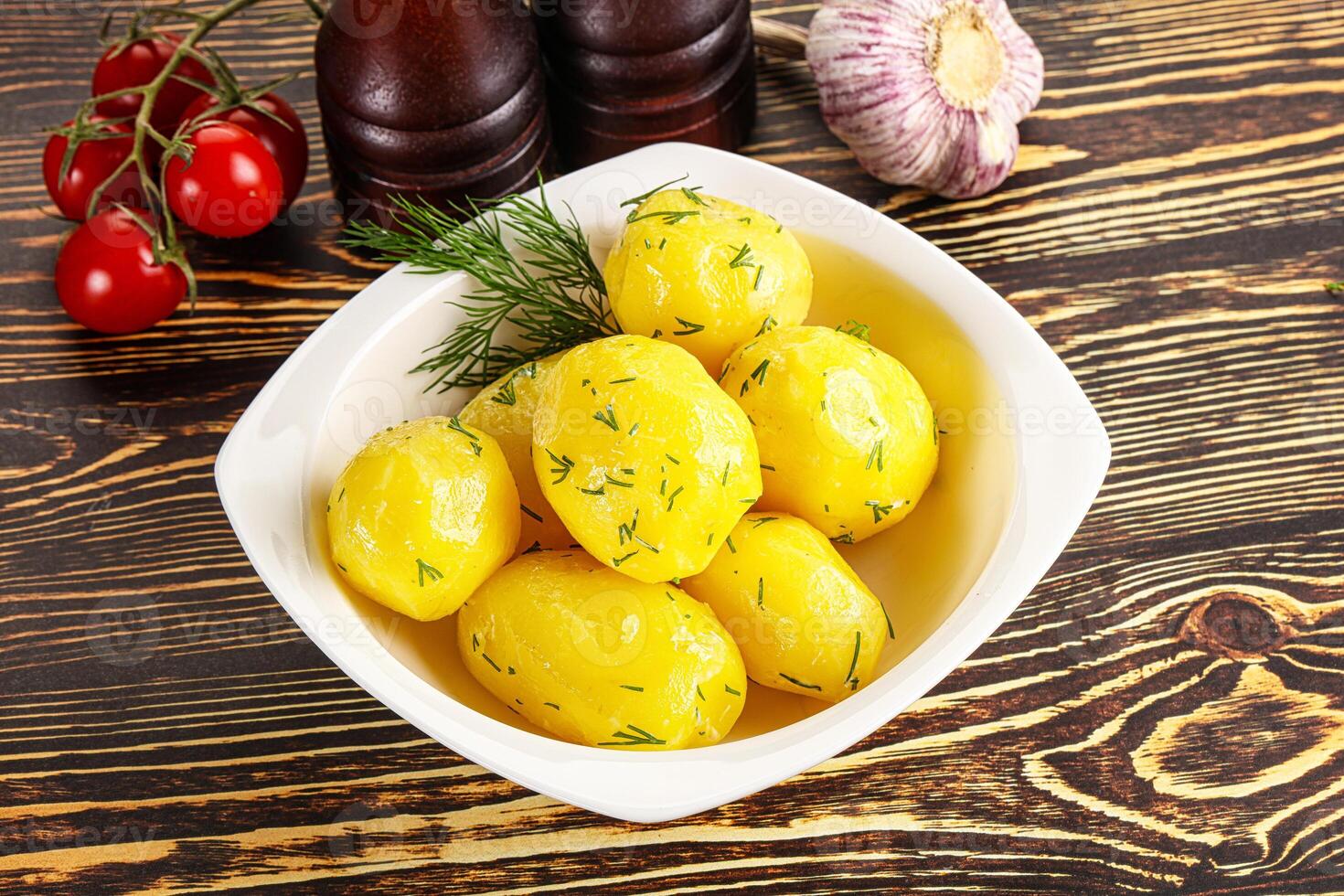 Boiled potato with oil and dill photo