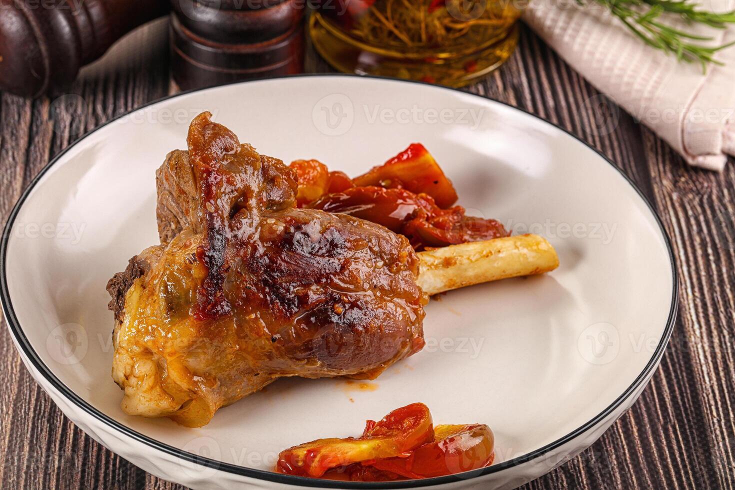 Baked lamb shank with vegetables photo