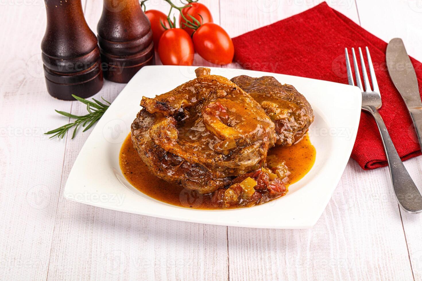 Italian cuisine - ossobuco with sauce photo