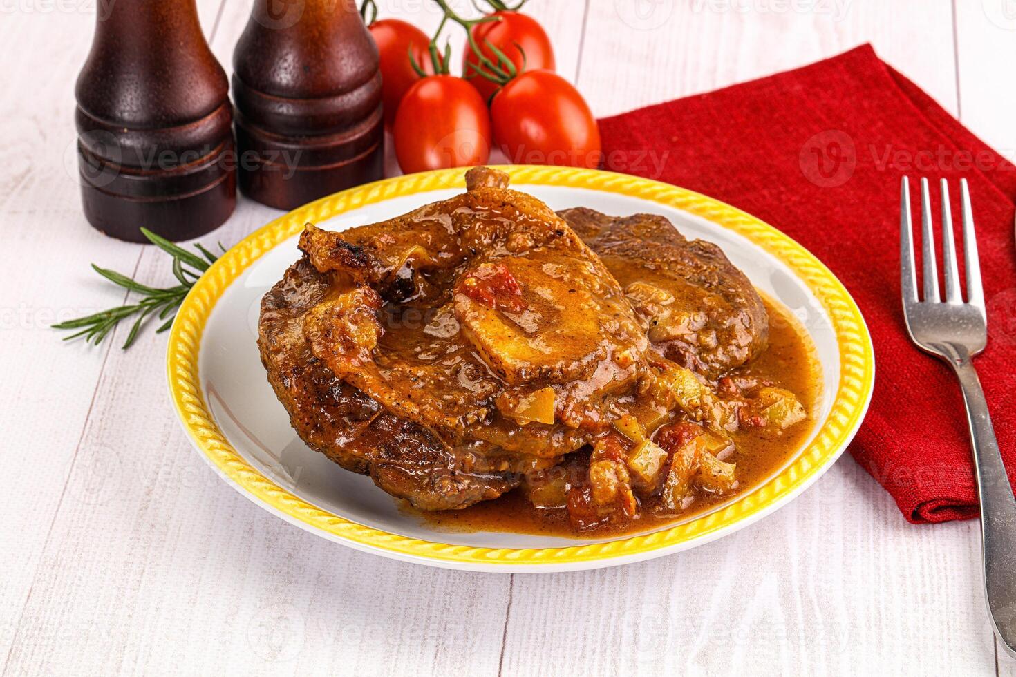 Italian cuisine - ossobuco with sauce photo