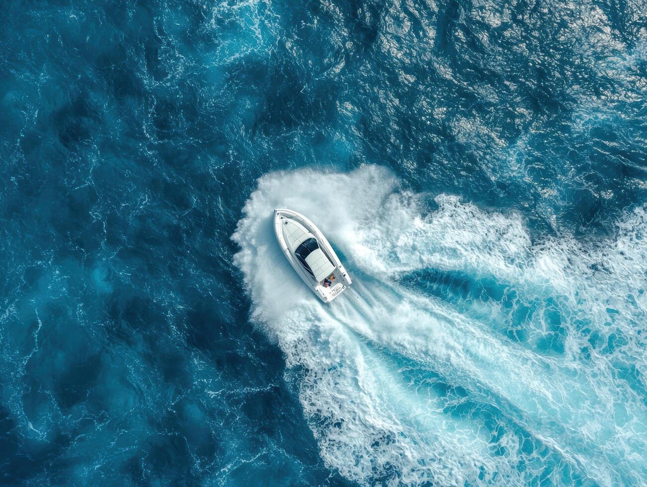 Aerial view of a speedboat racing across the open ocean photo