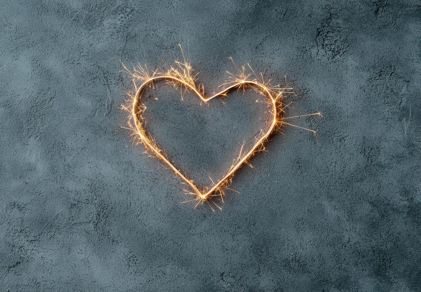 Sparkling heart shaped light on dark background photo
