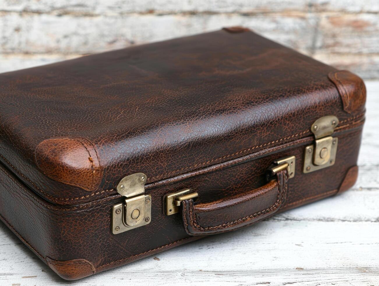 Vintage leather suitcase on wooden background photo