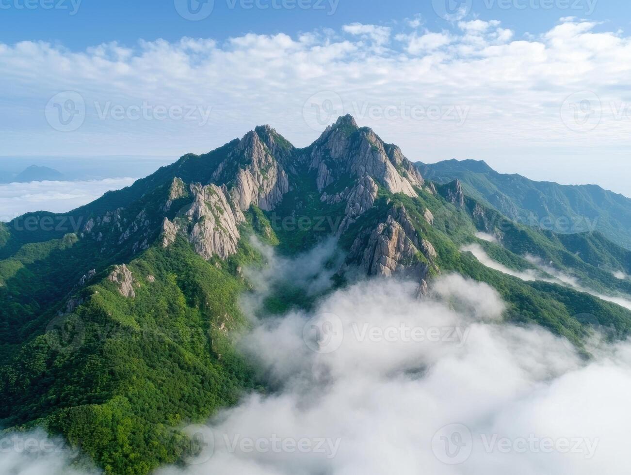 Majestic mountain peaks in the clouds photo