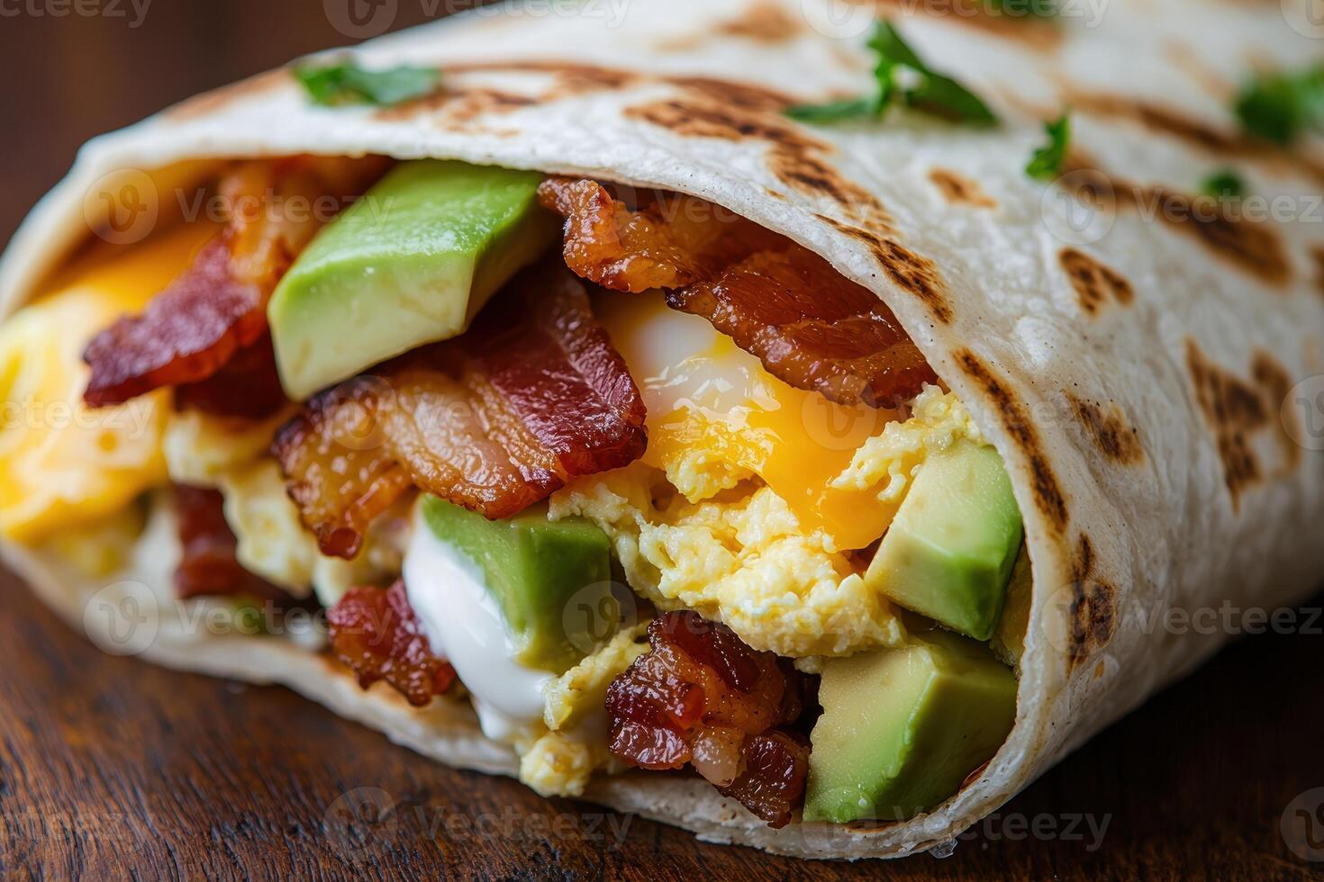 Delicious breakfast burrito with scrambled eggs, avocado, and bacon photo