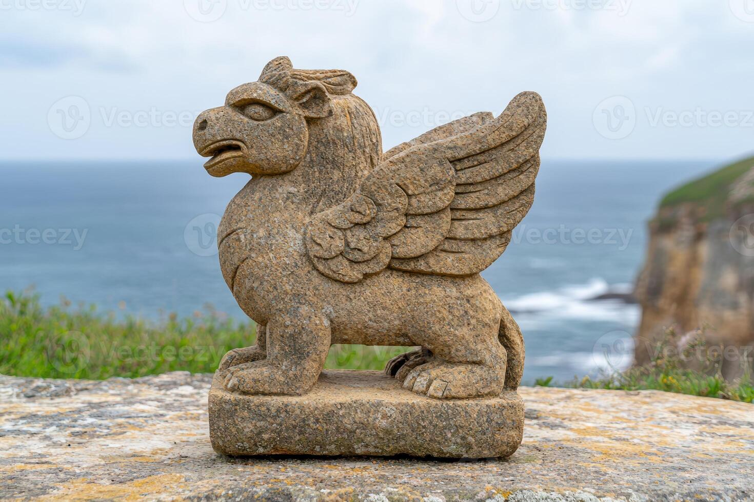 Mythical stone creature overlooking the ocean photo