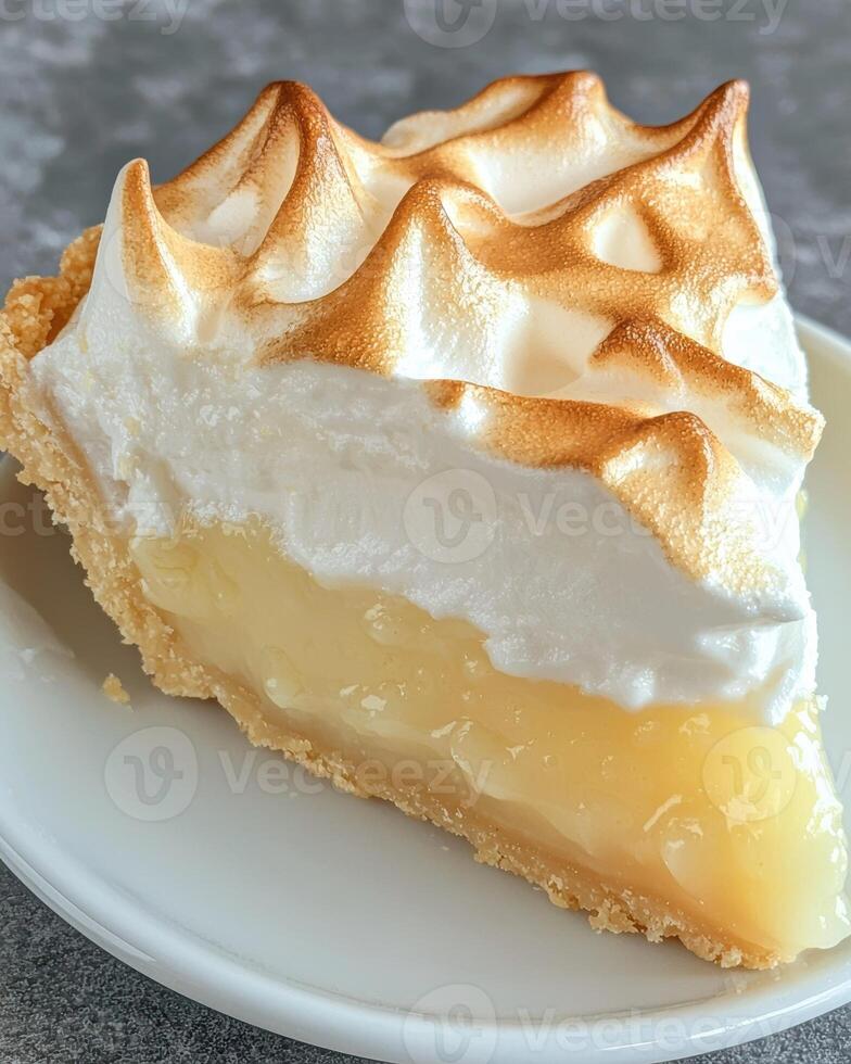 Delicious lemon meringue pie slice on plate photo