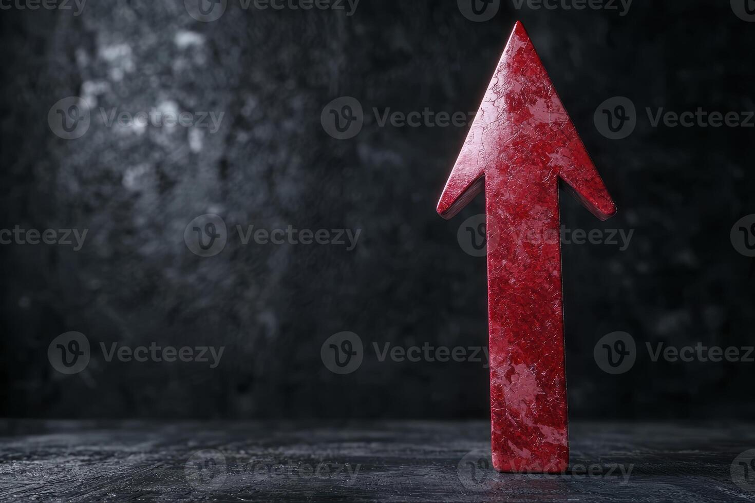 Dramatic red arrow pointing upwards on dark background photo