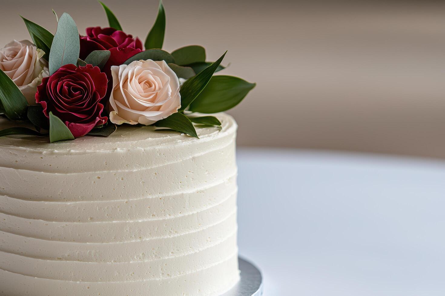 Elegant wedding cake with red and pink roses photo